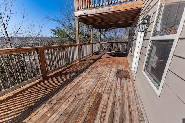 wooden deck featuring ceiling fan