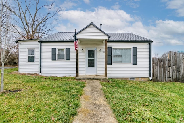 bungalow featuring metal roof, a front yard, and fence