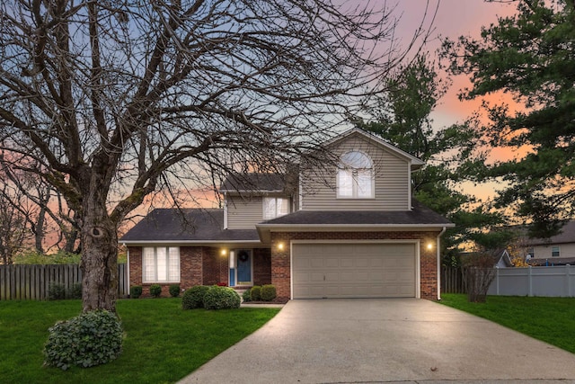 view of front property featuring a garage and a yard