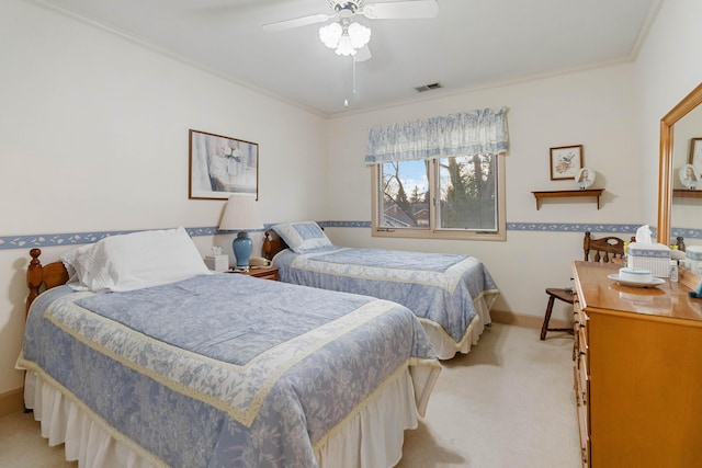 carpeted bedroom featuring ceiling fan and ornamental molding