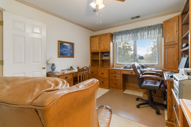 home office with ceiling fan, ornamental molding, and light colored carpet