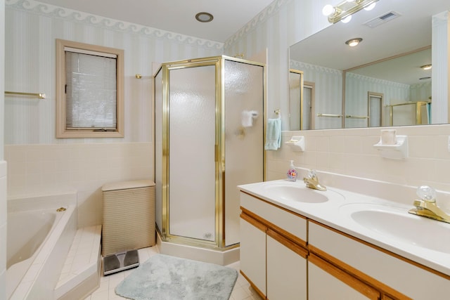 bathroom featuring tile walls, vanity, independent shower and bath, and tile patterned floors