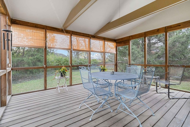 unfurnished sunroom featuring vaulted ceiling and a healthy amount of sunlight