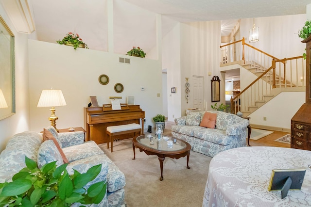 carpeted living room with a high ceiling