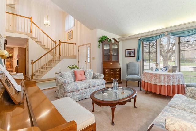 living room featuring carpet floors, a towering ceiling, and a textured ceiling