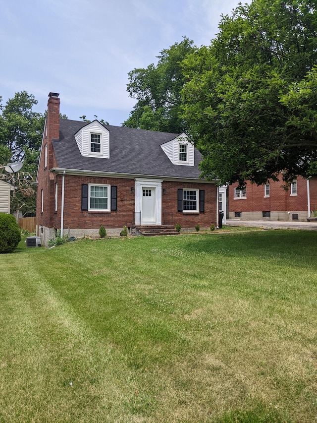 cape cod house featuring central AC and a front lawn