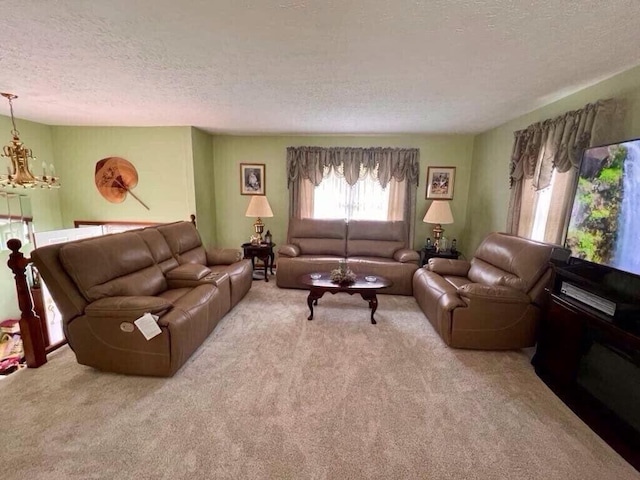 living room featuring carpet floors, a chandelier, and a textured ceiling