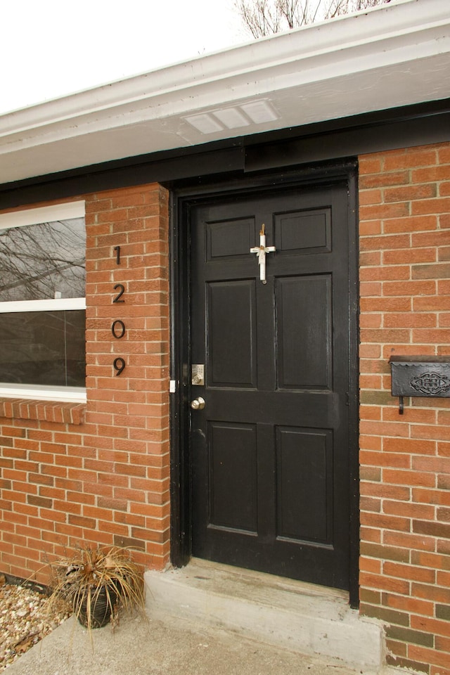 rear view of house with a patio area, a lawn, and brick siding