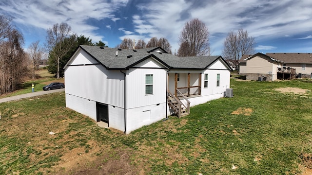 view of home's exterior featuring a yard and roof with shingles