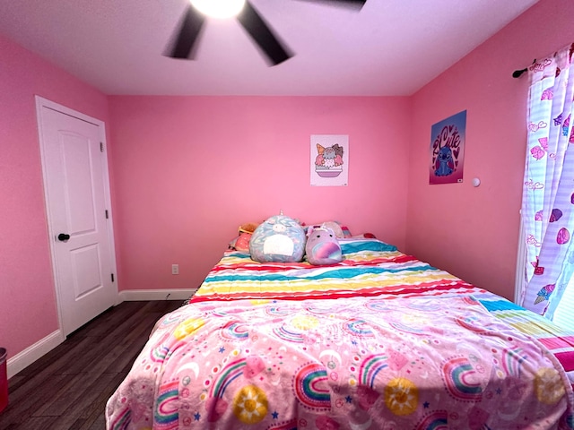 bedroom with baseboards, a ceiling fan, and dark wood-style flooring