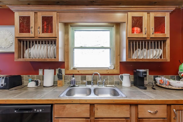 kitchen with sink, tile counters, and dishwasher