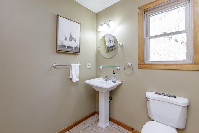 bathroom featuring sink, toilet, and tile patterned flooring