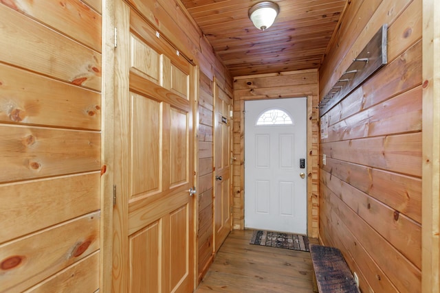 entryway with wood ceiling, hardwood / wood-style flooring, and wood walls