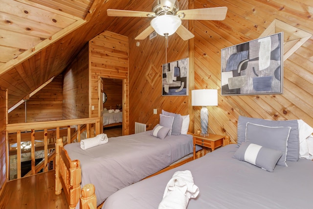 bedroom featuring vaulted ceiling, hardwood / wood-style floors, wood walls, ceiling fan, and wood ceiling