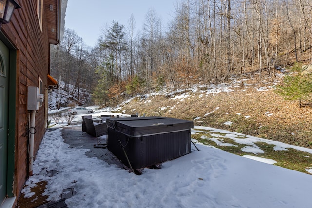 yard covered in snow with a hot tub