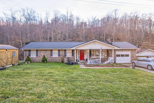 ranch-style house featuring a garage, a front lawn, and a porch