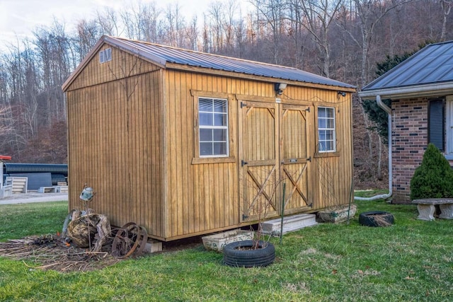 view of outbuilding with a lawn