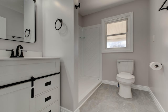 bathroom with a shower, vanity, and toilet