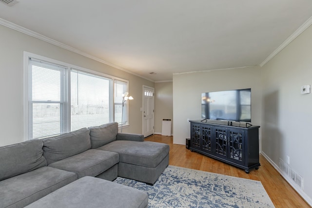 living room featuring hardwood / wood-style flooring and ornamental molding