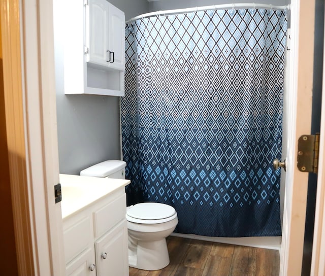 bathroom with toilet, vanity, hardwood / wood-style floors, and a shower with shower curtain