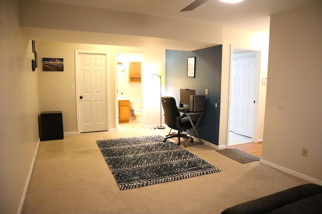 office area featuring light carpet and ceiling fan