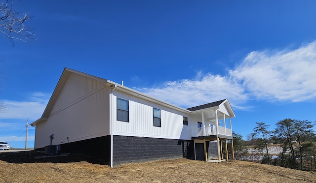 view of side of home with a balcony and central air condition unit