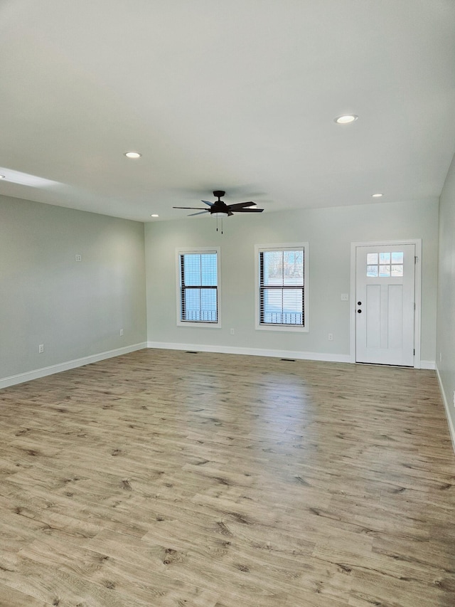 unfurnished living room with recessed lighting, baseboards, ceiling fan, and light wood finished floors