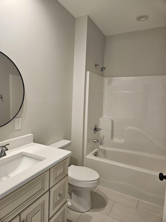 bathroom featuring toilet, tile patterned floors, vanity, and shower / bathing tub combination