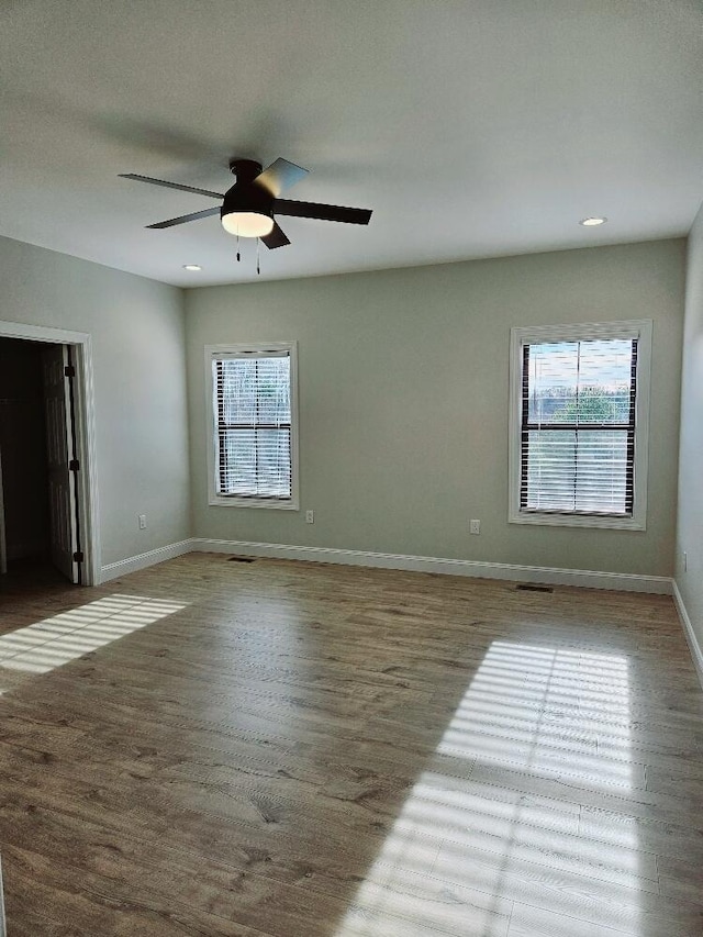 interior space featuring recessed lighting, ceiling fan, baseboards, and wood finished floors