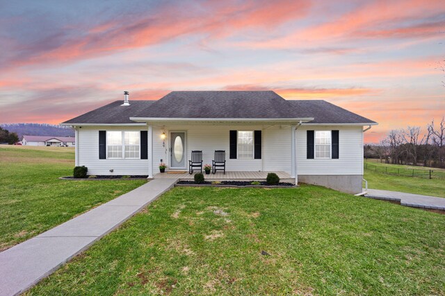 view of front facade featuring a lawn and covered porch