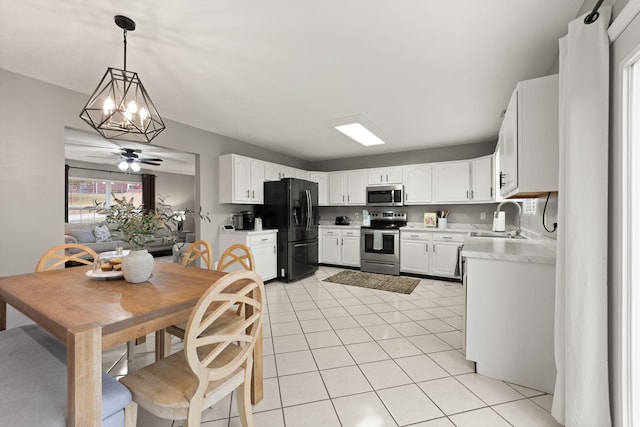 349 Sycamore Dr, Bronston, KY 42518 - kitchen featuring appliances with stainless steel finishes, pendant lighting, light tile patterned floors, sink, and white cabinetry