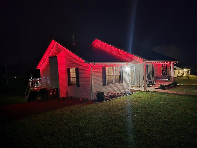 349 Sycamore Dr, Bronston, KY 42518 - back house at night with a yard and a patio area