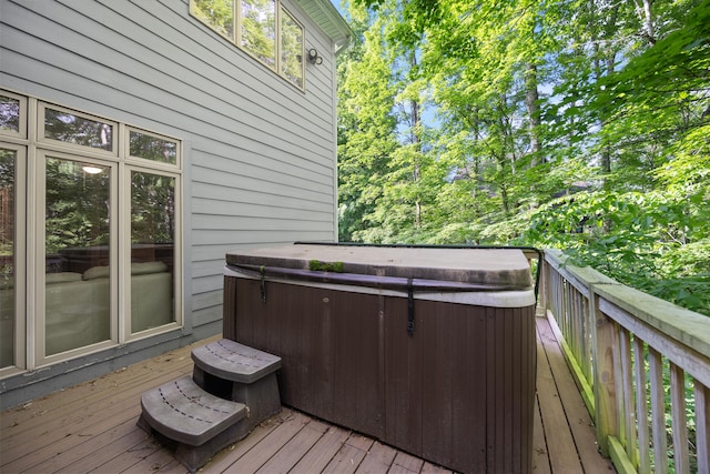 wooden terrace featuring a hot tub