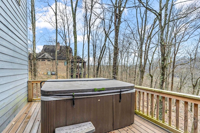 wooden deck featuring a hot tub