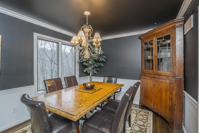 dining area featuring a chandelier, wainscoting, crown molding, and dark wood-style flooring