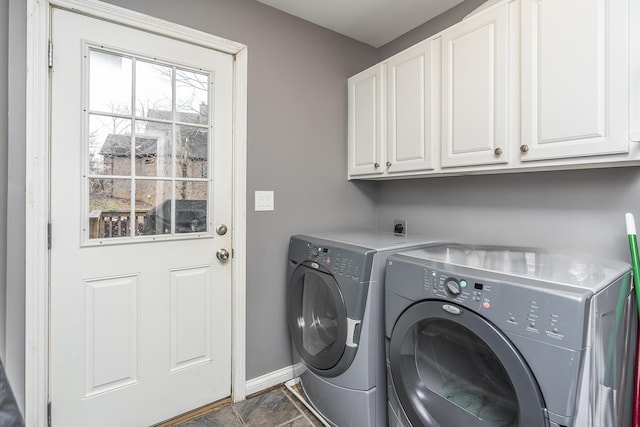 laundry room featuring cabinet space, washer and clothes dryer, and baseboards