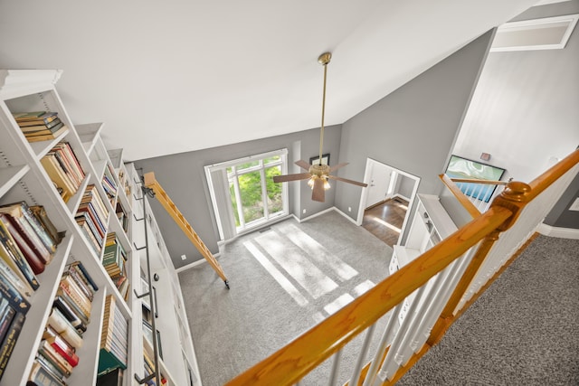 stairway featuring carpet flooring, vaulted ceiling, baseboards, and a ceiling fan