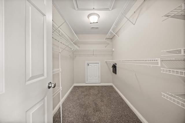 spacious closet with carpet floors and attic access