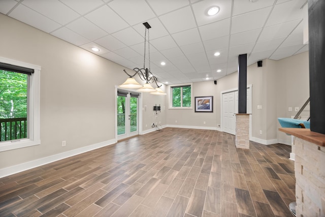unfurnished living room with baseboards, wood finished floors, and recessed lighting