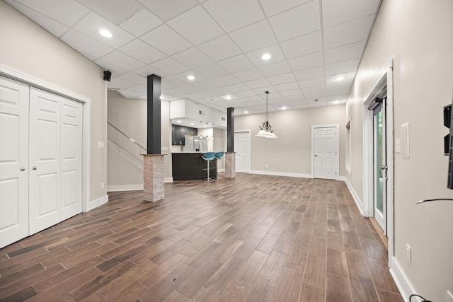 unfurnished living room with dark wood finished floors and baseboards