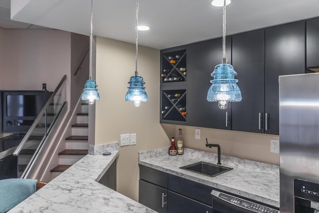 kitchen with stainless steel refrigerator with ice dispenser, a sink, dark cabinets, and dishwasher