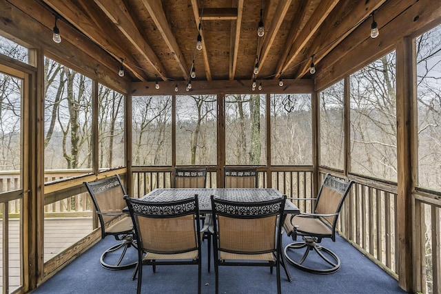 sunroom / solarium featuring outdoor dining space