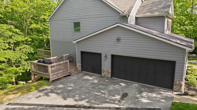 312 Avawam Dr, Richmond, KY 40475 - view of side of property with a shingled roof, stone siding, a garage, and concrete driveway