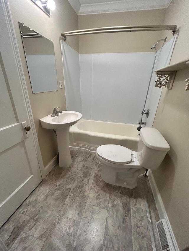 bathroom featuring crown molding, shower / tub combination, and toilet