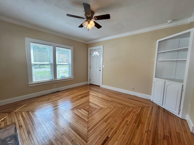 interior space featuring ornamental molding and ceiling fan