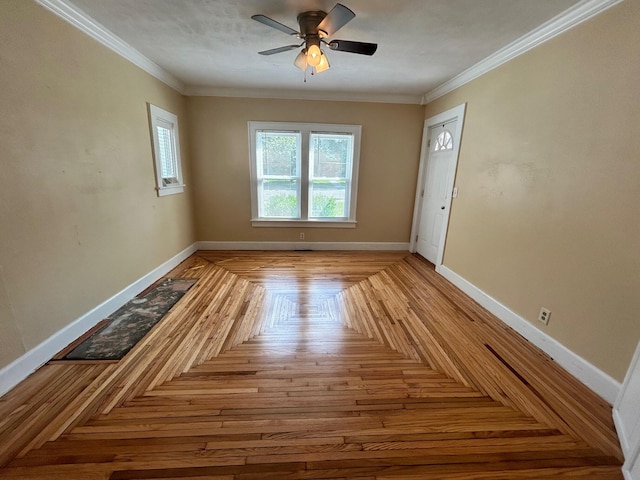 interior space featuring ceiling fan, ornamental molding, and light parquet floors