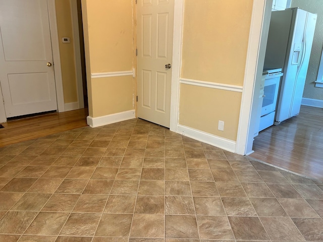 spare room with wood-type flooring