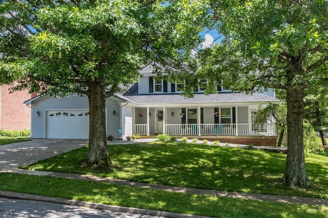 view of front of home with a garage, a front yard, and covered porch