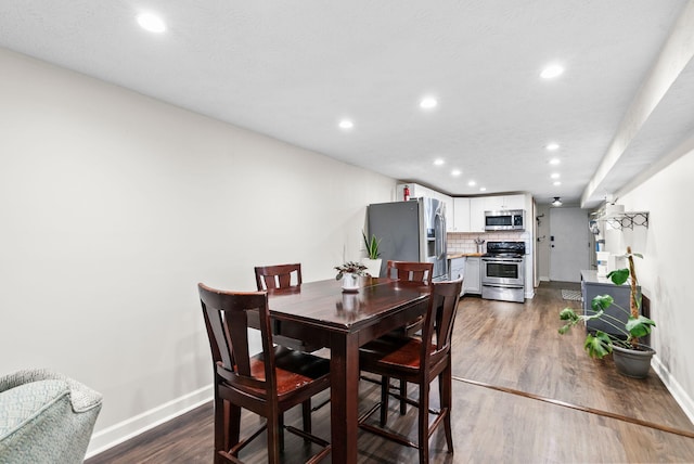 dining area featuring dark hardwood / wood-style floors