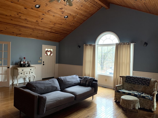 living area with wood ceiling, wainscoting, wood finished floors, and lofted ceiling